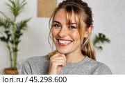 Joyful lady demonstrates use of skincare items. Her glowing skin and relaxed posture indicate effectiveness of products, capturing essence of daily beauty routine. Стоковое AI-изображение, AI-художник Павел Муравьев / Фотобанк Лори