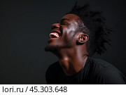 Handsome young cheerful African American man. Стоковое AI-изображение, AI-художник Klimiankova Tatsiana / Фотобанк Лори