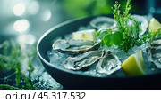 Свежие устрицы на колотом льду с зеленым гарниром для кулинарного наслаждения и морепродуктов. Стоковое AI-изображение, AI-художник ФотоИнтеллект / Фотобанк Лори