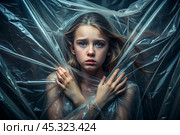 The girl is wrapped in cellophane or a bag. The girl is suffocating. Plastic pollution of the planet. Environmental hazard. Reducing the reuse of plastic. Recycling. The concept of garbage. Стоковое AI-изображение, AI-художник Photojuli / Фотобанк Лори