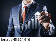 The concept of value growth in real estate, energy efficiency rating. Real estate online on virtual screens. New family housing, apartment purchase, house search, land price, real estate tax. Стоковое AI-изображение, AI-художник Photojuli / Фотобанк Лори