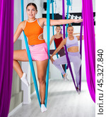 Women making antigravity yoga exercises in stretching twine. Стоковое фото, фотограф Яков Филимонов / Фотобанк Лори
