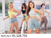Group of girls unleash their energy and dance passionately near a chair in high heels in a dance studio. His powerful moves combined with elegance of high heels. Стоковое фото, фотограф Яков Филимонов / Фотобанк Лори