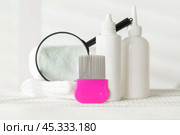 Lice treatment product next to a nit comb and magnifying glass. Стоковое фото, фотограф Сергей Толмачёв / Фотобанк Лори