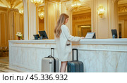 Tourist checking in at luxurious hotel reception desk with suitcases. Стоковое AI-изображение, AI-художник Юрий Поздников / Фотобанк Лори