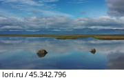 Stones with reflection in smooth water. Стоковое видео, видеограф Михаил Коханчиков / Фотобанк Лори