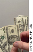 Vertical video of men's hands counting paper money American dollars. $20 bills fall on a light table. Flat lay, close-up, top view, copy space, mock up. Стоковое видео, видеограф Виктория Катьянова / Фотобанк Лори