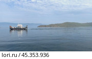 Video of Baikal Lake in summer. View from ship board to a passenger ferry with tourists from the famous Olkhon Island on a sunny summer day. Стоковое видео, видеограф Виктория Катьянова / Фотобанк Лори