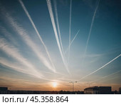Chemtrail conspiracy theory. Long-lasting condensation trails left in sky by high-flying aircraft are actually chemtrails consisting of chemical or biological agents, sprayed for nefarious purposes. Стоковое AI-изображение, AI-художник Юлия Петровская / Фотобанк Лори