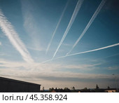 Chemtrail conspiracy theory. Long-lasting condensation trails left in sky by high-flying aircraft are actually chemtrails consisting of chemical or biological agents, sprayed for nefarious purposes. Стоковое AI-изображение, AI-художник Юлия Петровская / Фотобанк Лори