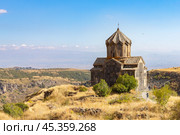 Famous view to ancient Vahramashen church of the 11th century, located near destroyed Amberd fortress in sunny summer day. Cliff with Arkashian River deep in canyon. Aragatsotn, Armenia. Стоковое фото, фотограф Алексей Ширманов / Фотобанк Лори
