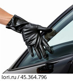 Thief wearing black gloves reaching inside car window. Стоковое AI-изображение, AI-художник Иван Рябоконь / Фотобанк Лори