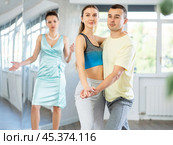 Couple rehearsing elegant tango under guidance of female teacher. Стоковое фото, фотограф Яков Филимонов / Фотобанк Лори