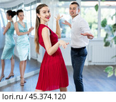 Couple in stage costumes learns boogie woogie dancing during individual lesson. Стоковое фото, фотограф Яков Филимонов / Фотобанк Лори