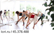 Expressive female dance instructor leading with confidence group rehearsal, performing sensual choreography in high heels, epitomizing modern grace and femininity in sunlit studio. Стоковое видео, видеограф Яков Филимонов / Фотобанк Лори