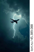 The aircraft encounters a severe thunderstorm, surrounded by dark clouds and illuminated by bright lightning strikes, highlighting the danger in the sky. Causes of air crashes. Generative AI. Стоковое AI-изображение, AI-художник Юлия Петровская / Фотобанк Лори