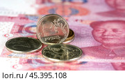 Money. One Russian ruble against the background of the Chinese yuan. Стоковое фото, фотограф Igor Skripachev / Фотобанк Лори