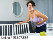 Young woman holding hands on the illness stomache. Стоковое фото, фотограф Яков Филимонов / Фотобанк Лори