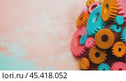 Colorful gears connecting on pastel pink and blue background representing teamwork and collaboration. Стоковое AI-видео, аниматор Юрий Поздников / Фотобанк Лори
