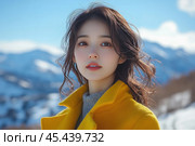 Young woman against the backdrop of snowy mountain landscapes. She is wearing a bright yellow coat and a gray sweater, which highlight her delicate features. Her hair is gently blown by the wind, and her gaze is directed at the camera, creating an atmosphere of calm and harmony. The blue sky and white snow complement the image, emphasizing the contrast of colors. Стоковое AI-изображение, AI-художник Анна Кривицкая / Фотобанк Лори