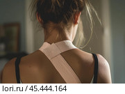 Young woman wearing kinesiotape standing at home. Стоковое AI-изображение, AI-художник Иван Рябоконь / Фотобанк Лори