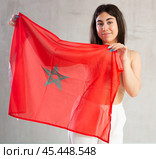 Happy young woman with flag of Monaco against unicoloured background. Стоковое фото, фотограф Яков Филимонов / Фотобанк Лори