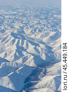 Aerial view of snow-capped mountains. Winter snowy mountain landscape. Air travel to the far North of Russia. Nuh River and Mount Nuh, Kolyma Mountains, Magadan Region, Siberia, Russian Far East. Стоковое фото, фотограф Андрей Степанов / Фотобанк Лори
