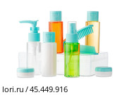Variety of colorful personal care bottles and grooming accessories arranged on a white surface. Стоковое фото, фотограф Сергей Толмачёв / Фотобанк Лори