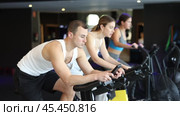 Man performs exercises with stationary bicycle in gym. Стоковое видео, видеограф Яков Филимонов / Фотобанк Лори