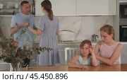 Worried teenage girls, filled with disappointment, shielding ears, refusing to hear scolding of mother and father standing in background. Selective focus on quarreling parents. Стоковое видео, видеограф Яков Филимонов / Фотобанк Лори