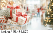 Shopping cart filled with wrapped gifts in Christmas, New Year festive store background, Black Friday sale. Стоковое AI-изображение, AI-художник Анастасия Золотницкая / Фотобанк Лори