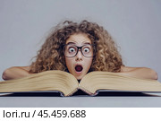 Surprised girl in front of a huge book. Стоковое AI-изображение, AI-художник Дмитрий Киселёв / Фотобанк Лори