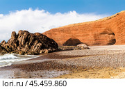 Spectacular natural red arch on atlantic ocean coast, Legzira (or Gzira) beach. Red archs on atlantic ocean coast. Sidi Ifni, Morocco, Africa (2024 год). Стоковое фото, фотограф Евгений Ткачёв / Фотобанк Лори