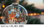 Ornate Christmas bauble with a miniature winter village inside, hanging on a tree branch with blurred festive lights. Стоковое AI-видео, аниматор Ольга Сухарева / Фотобанк Лори