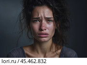 Portrait of a crying caucasian girl with bruised skin on grey studio background. Domestic violence, portrait of abused and hurt young woman crying at home. Sadness and depression concept. Стоковое AI-изображение, AI-художник Sergey Grishin / Фотобанк Лори