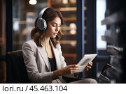 Businesswoman wearing headphones watching video webinar making conference online call writing notes talking, focused woman study online looking at laptop listening translating lecture course. Стоковое AI-изображение, AI-художник Sergey Grishin / Фотобанк Лори