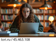 Happy Caucasian teen girl school or college student working on laptop doing homework or preparing for exam in library sitting at desk. Learning math and individual schoolwork concept, close up view. Стоковое AI-изображение, AI-художник Sergey Grishin / Фотобанк Лори