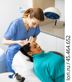 Woman cosmetician giving face injections of botulinum toxin for young woman. Стоковое фото, фотограф Яков Филимонов / Фотобанк Лори
