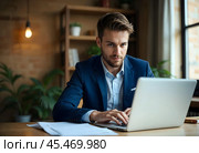 A businessman is working on a laptop. Стоковое AI-изображение, AI-художник RamA / Фотобанк Лори