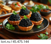 Tartlets with black caviar. A beautiful and original snack for a festive table. Enjoy your meal! Стоковое AI-изображение, AI-художник Сергей Елизарьев / Фотобанк Лори