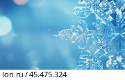 A detailed snowflake against a bright blue bokeh background with soft glowing light. zoom in, zoom out, pan, or 360 degree shot, animate. Стоковое AI-видео, аниматор ALLA YURTAYEVA / Фотобанк Лори