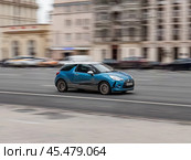 Blue Citroen DS3 hatchback is moving on asphalt road in autumn day in blurred urban landscape. Редакционное фото, фотограф Константин Григорьев / Фотобанк Лори