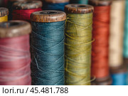 Colorful thread spools showing arts and crafts sewing concept. Стоковое AI-изображение, AI-художник Иван Рябоконь / Фотобанк Лори
