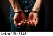 The man's hands are handcuffed. Стоковое AI-изображение, AI-художник RamA / Фотобанк Лори