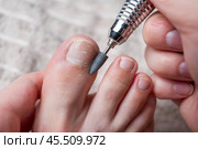 Hardware pedicure for yourself, ingrown toenail, chiropody and podology concept, foot care. Стоковое фото, фотограф Станислав Тарко / Фотобанк Лори