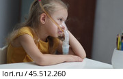 A bored and coughing sick girl is treated with a nebulizer. Стоковое видео, видеограф Кутина Татьяна / Фотобанк Лори