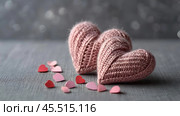 The banner. Background for Valentine's Day. Knitted hearts with festive lights in the form of a side in the background. a mock-up of an invitation card for a Valentine's Day party, a place to copy. Стоковое AI-изображение, AI-художник Photojuli / Фотобанк Лори