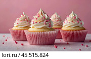 Festive cupcakes, baked with pastry sprinkles on a pink background with sequins, ideal for romantic celebrations. Valentine's Day, wedding. Стоковое AI-изображение, AI-художник Photojuli / Фотобанк Лори