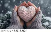 Women's hands in warm mittens hold a pink heart. Snow is falling. Valentine's Day and World Health, Love and Family Insurance Day. Стоковое AI-изображение, AI-художник Photojuli / Фотобанк Лори