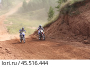 "Motocross race battle in Yuryevets" / "Борьба на мотокроссе в Юрьевце" "Summer motocross competition Yuryevets" / "Летние соревнования по мотокроссу в Юрьевце" "Motocross racing on Yuryevets track" / "Гонки мотокросса на трассе Юрьевца" "Intense motocross battle Yuryevets circuit" / "Напряженная гонка на трассе Юрьевца" "Regional motocross racing Yuryevets" / "Региональный мотокросс в Юрьевце" (2013 год). Редакционное фото, фотограф Сергей Расторгуев / Фотобанк Лори